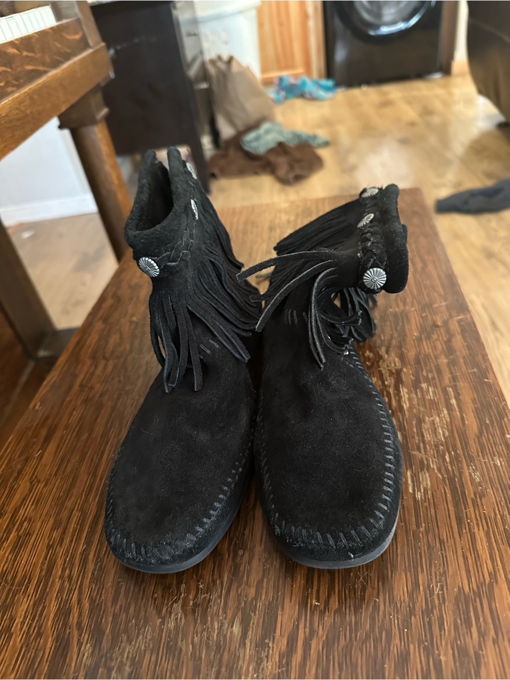 Women’s Minnetonka Black Suede Fringe Moccasin Boots, with zipper back.